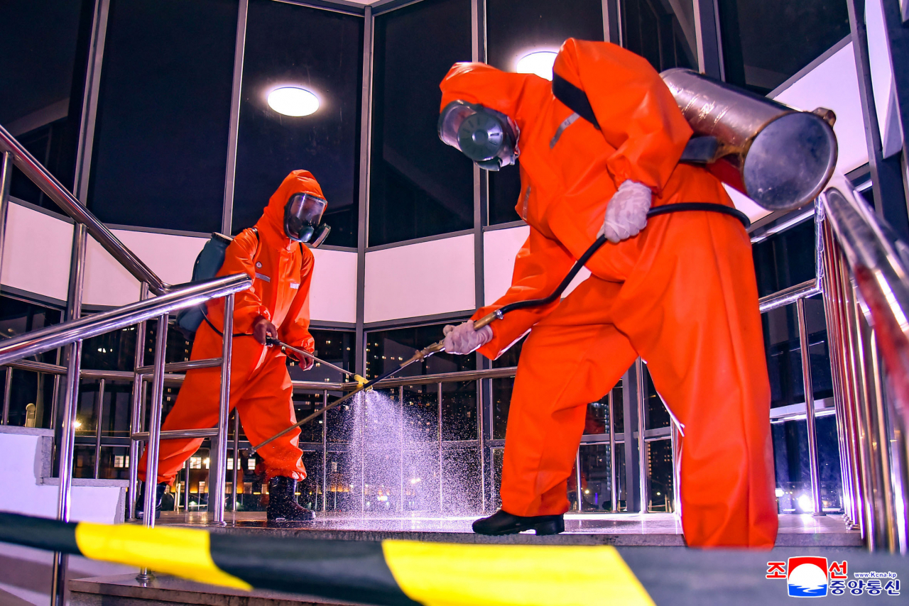 Workers carry out disinfection work in Pyongyang, in this photo released by the North's Korean Central News Agency on Tuesday. (KCNA)