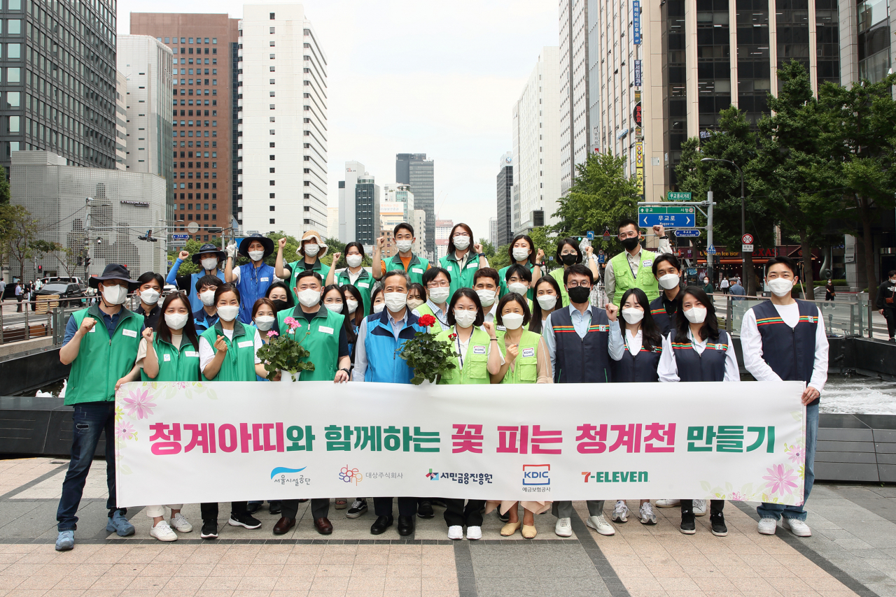 서민금융진흥원, 예금보험공사, 대상(주), 세븐일레븐 등 4개 기관 임직원 30여명이 서울 청계천 청계광장에서 ‘꽃 피는 청계천 만들기’ 활동을 실시했다.[서민금융진흥원 제공]
