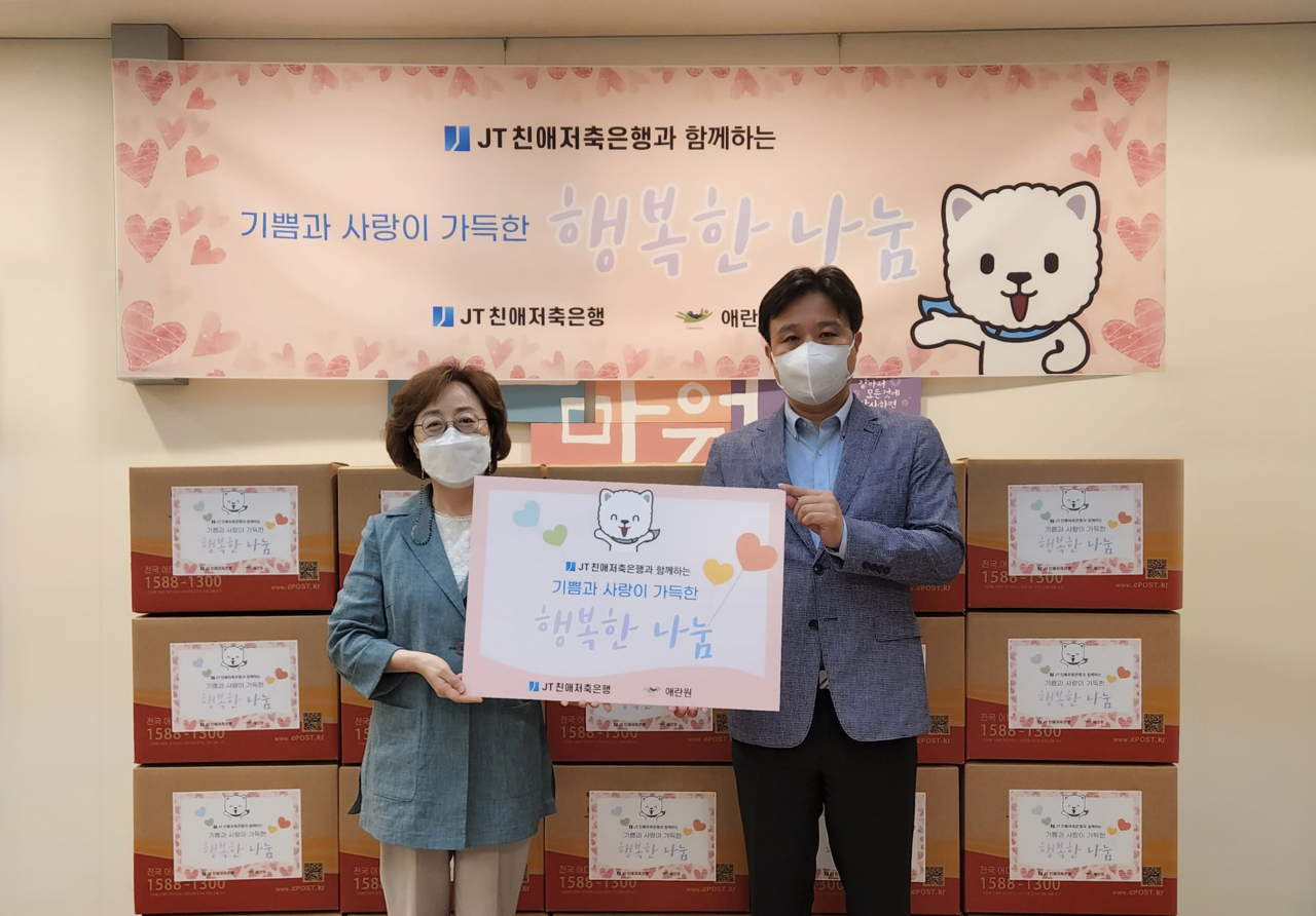 JT친애저축은행 지난 9일 '코로나19 극복을 위한 행복한 나눔' 행사를 열고 저소득 한부모 가정을 위한기부금을 미혼·한부모 복지시설인 애란원에 전달했다. 강영실(사진 왼쪽) 애란원 원장과 조승진 JT친애저축은행 마케팅전략부 부장이 기념촬영을 하고 있다.[JT친애저축은행 제공]