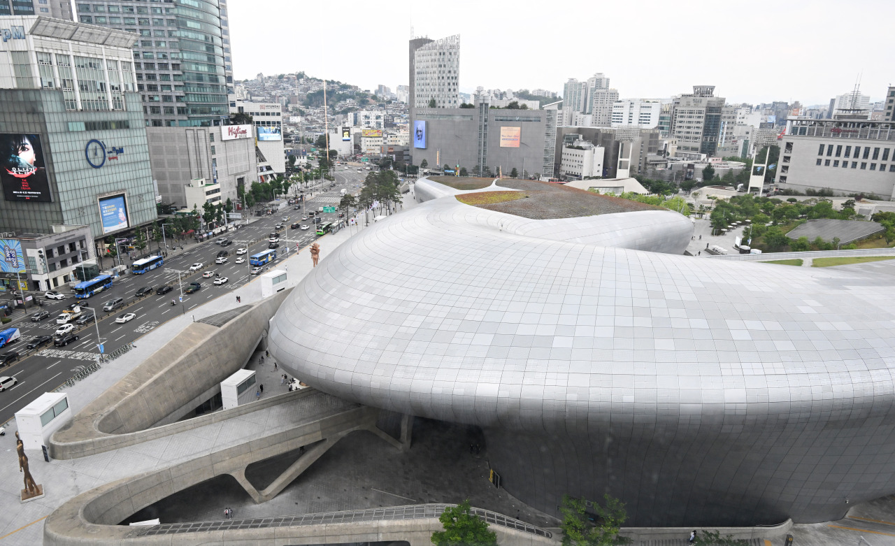 Dongdaemun Design Plaza silver curved metallic exterior at night designed by Zaha Hadid in Jung-gu Seoul