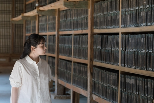 This photo provided by the Cultural Heritage Administration shows actress Kim Min-ha in a scene from a video to promote tourism to Haein Temple in Hapcheon, some 240 kilometers south of Seoul, home of the Tripitaka Koreana. (CHA).