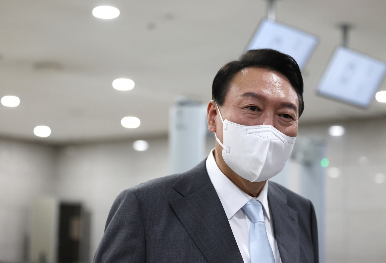 President Yoon Suk-yeol takes reporters' questions as he arrives at the presidential office in Seoul on Wednesday. (Yonhap)