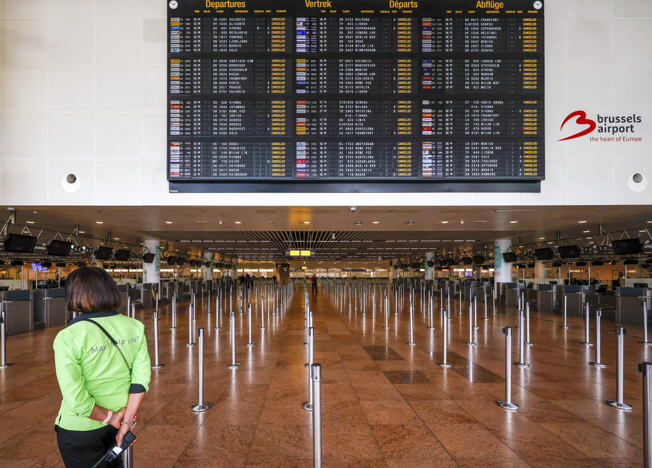 지난 20일(현지시간) 벨기에 브뤼셀 국제공항이 공항 보안요원들의 파업으로 전체 출발편의 운행이 중단되는 등 마비 상태에 빠진 가운데, 한 공항 안내 요원이 모든 출발편에 ‘운항 취소(cancelled)’가 표시된 전광판을 바라보고 있다. [AP]