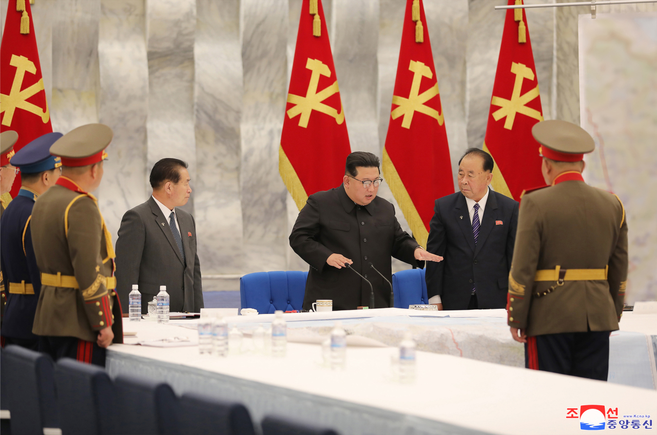 North Korean leader Kim Jong-un (center) speaks during a meeting of the central military commission of the Workers' Party in Pyongyang on its second day on Wednesday in this photo provided by the state-run Korean Central News Agency. (Yonhap)