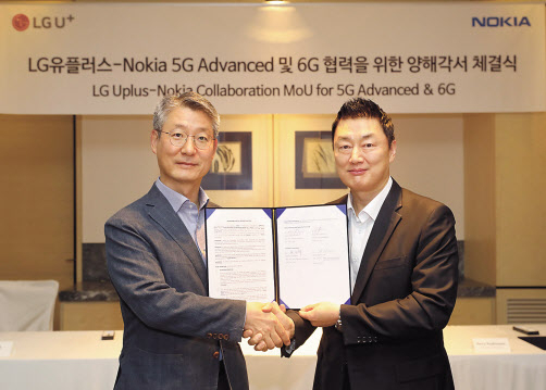 서울 광화문 포시즌스호텔에서 노키아가 개최한 MWC 2022 Revisited 행사에서 권준혁(왼쪽) LG유플러스 네트워크부문장과 안태호 노키아 코리아 대표가 업무협약을 체결하고 있다. [LG유플러스 제공]