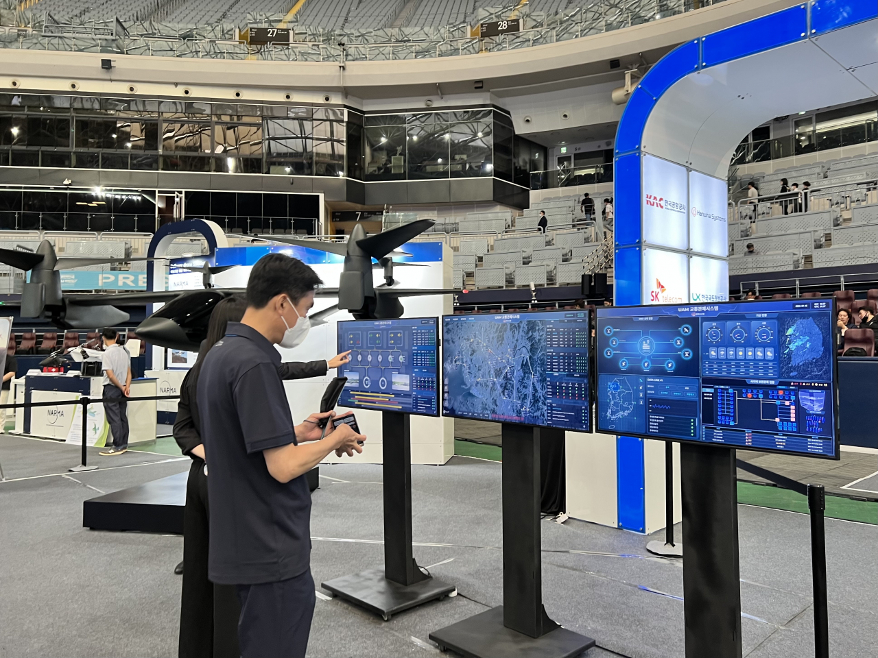 2022 대한민국 드론·UAM 박람회가 지난 15일 서울 구로구 고척스카이돔에서 열렸다. 한 관람객이 한화시스템이 전시한 UAM 교통관제시스템을 살펴보며 관계자들의 설명을 듣고 있다. [사진=김은희 기자]