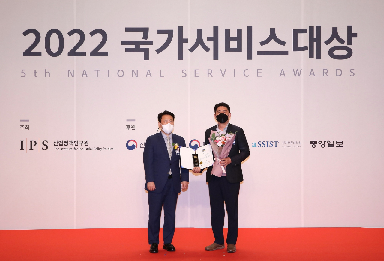 넥센타이어 한국지역 황충상(오른쪽) BS장이 지난 14일 서울 스위스 그랜드호텔에서 열린 ‘2022 국가서비스대상’ 시상식에서 이성호 산업정책연구원 심사위원장과 기념 촬영을 하고 있다. [넥센타이어 제공]