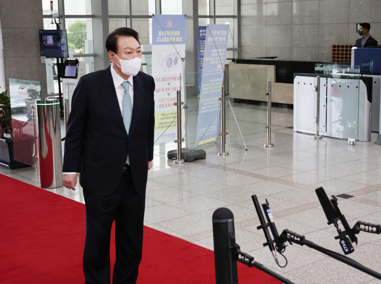 President Yoon Suk-yeol takes reporters' questions as he arrives at the presidential office in Seoul on Thursday. (Yonhap)