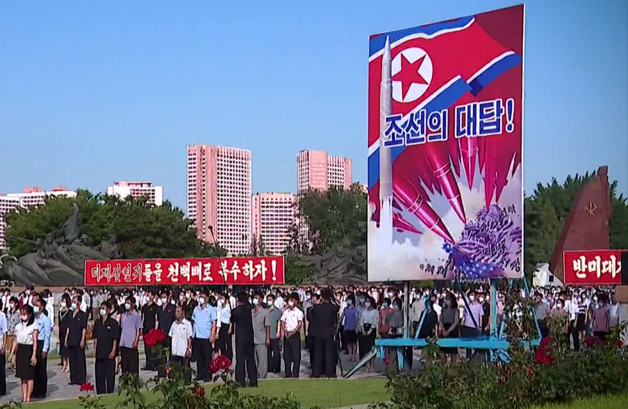 This photo, captured from a clip from North Korea's Central TV, shows an anti-American youth rally in Pyongyang on June 25, 2022, with a propaganda painting depicting North Korean ICBMs striking the U.S. Capitol. The rally took place on the occasion of the 72nd anniversary of the Korean War. (Yonhap)
