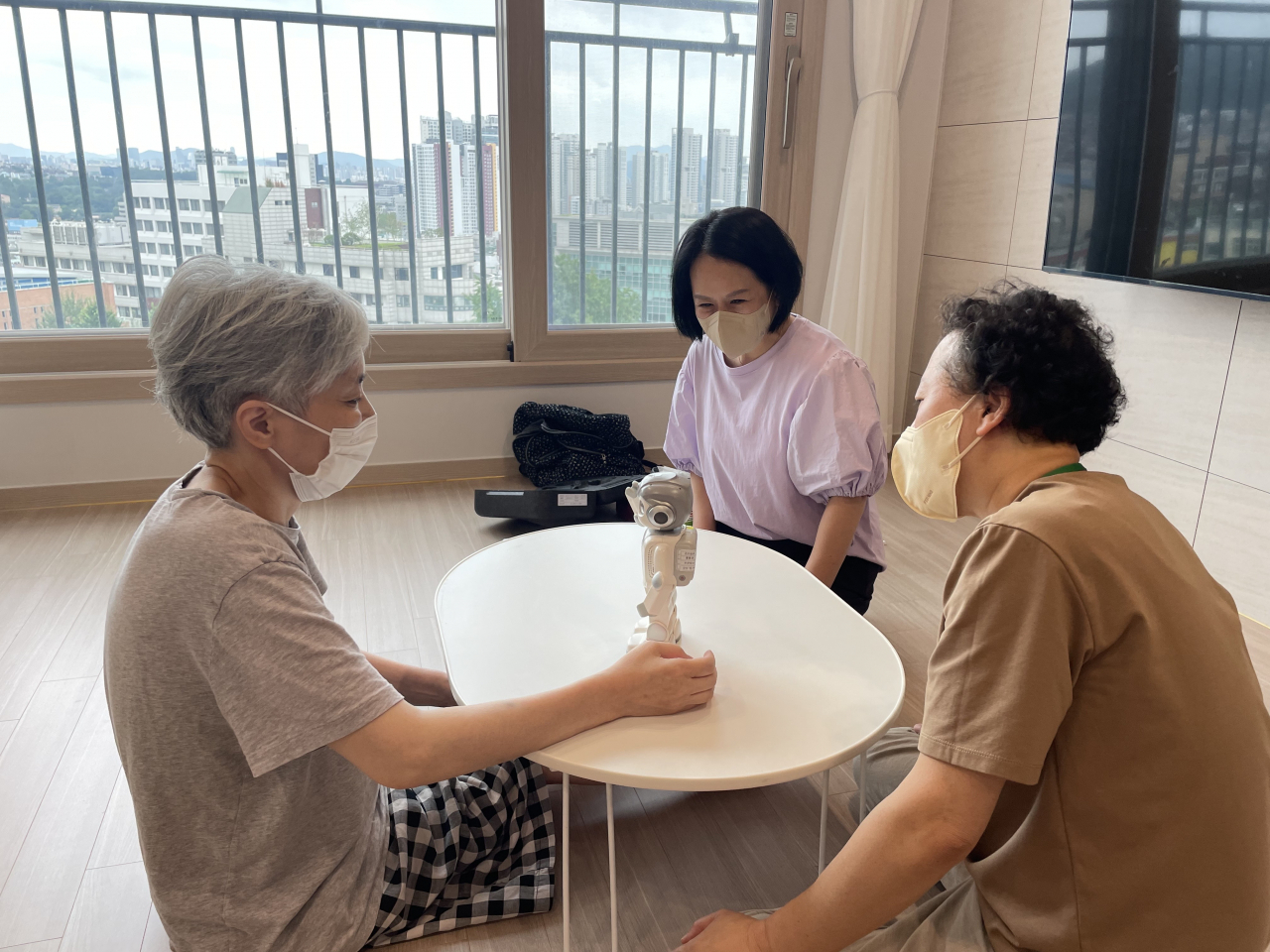 서울 용산구 치매안심전문 자원봉사단이 어르신 자택에 방문해 인공지능로봇과 학습을 진행하고 있다. [용산구 제공]
