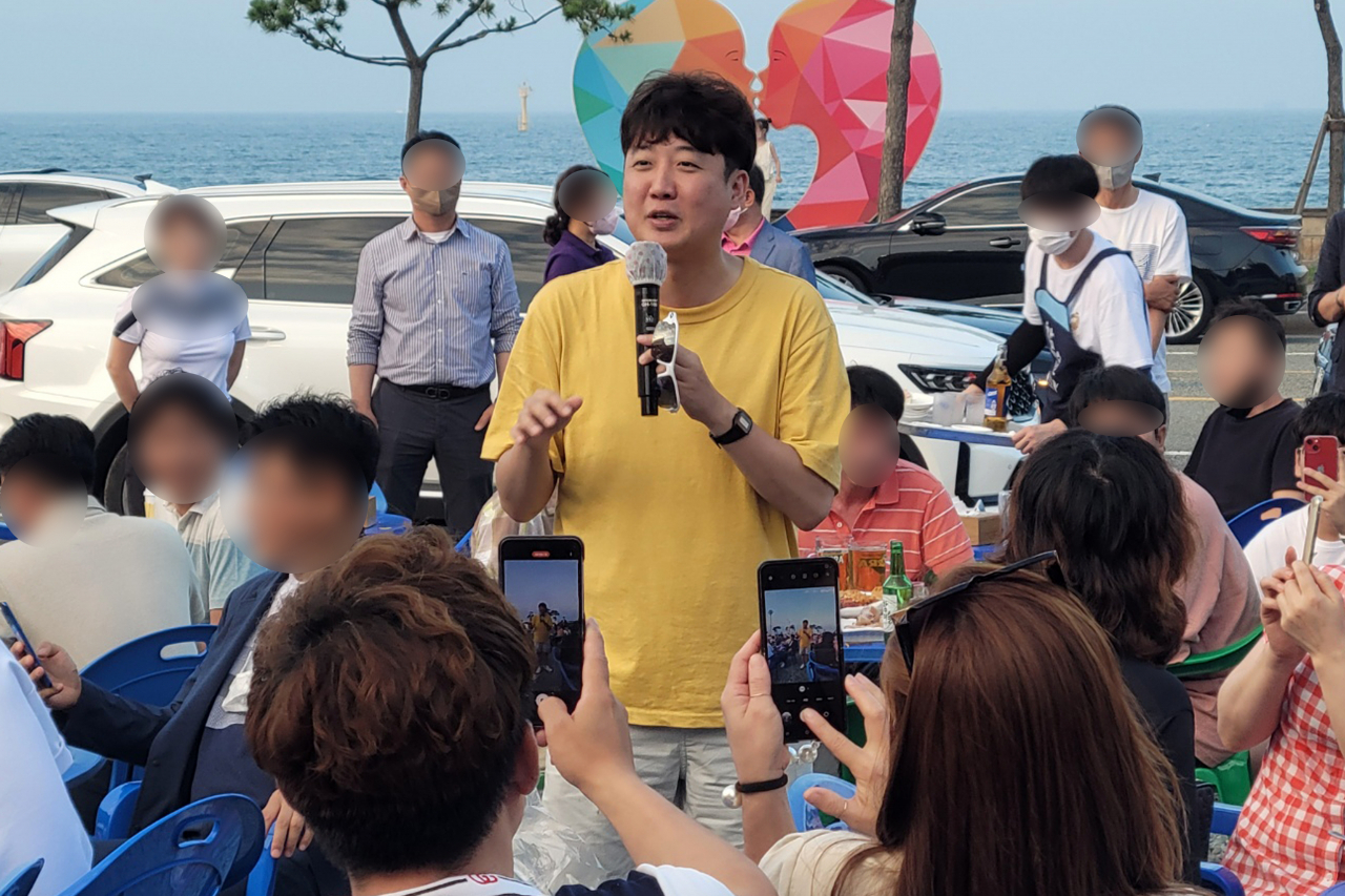 24일 저녁 경북 포항 송도해변 한 통닭식당에서 국민의힘 이준석 대표가 지지자나 포항시민과 치킨을 나눠 먹으며 대화하는 '번개모임'을 하고 있다. [연합]