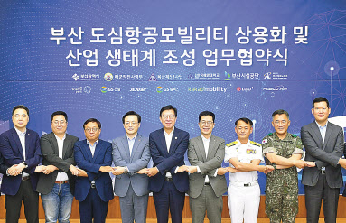 27일 부산시청에서 열린 도심항공모빌리티(UAM) 상용화 및 산업생태계 조성 업무협약식에서 박형준 부산시장(왼쪽 첫번째)과 허윤홍 GS건설 신사업부문 대표(오른쪽 첫번째) 등 각 사 관계자들이 참석해 기념 촬영하고 있다. [GS건설 제공]