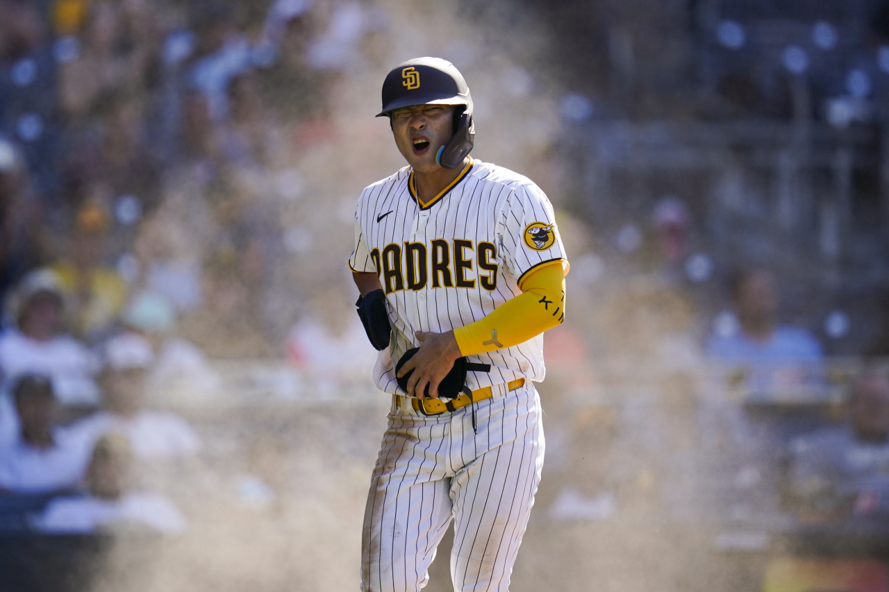 In this Associated Press photo, Kim Ha-seong of the San Diego Padres reacts after sliding home safely against the Colorado Rockies during the bottom of the eighth inning of a Major League Baseball regular season game at Petco Park in San Diego on Wednesday. (Associated Press)