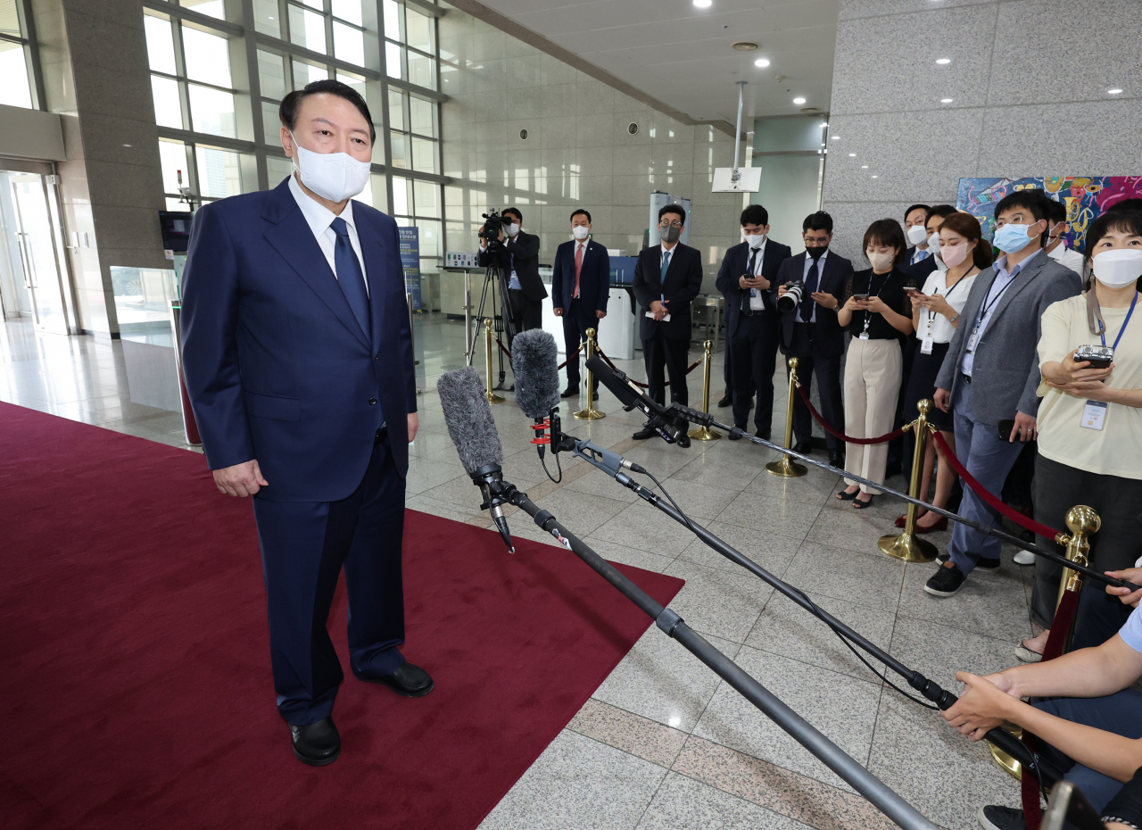 President Yoon Suk-yeol takes reporters' questions as he arrives at the presidential office in Seoul on Aug. 12, 2022. (Yonhap)