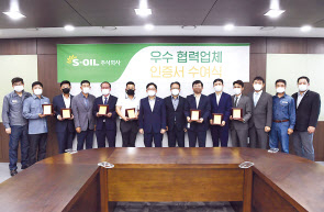 서강돈(왼쪽 일곱번째) S-OIL 전무가 협력업체들에게 우수업체 인증서를 수여한 뒤 기념사진을 찍고 있다. [S-OIL 제공]