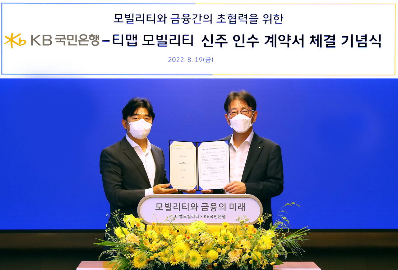 지난 19일 서울시 중구에 위치한 SKT타워에서 열린 KB국민은행-티맵모빌리티 전략적 투자 계약 체결식에서 (왼쪽)이종호 티맵모빌리티 대표와 (오른쪽)이재근 KB국민은행장이 기념촬영을 하고 있다.