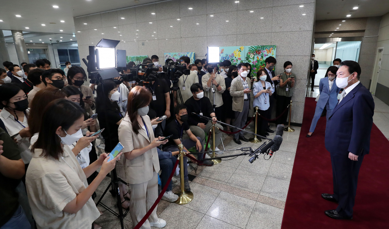 President Yoon Suk-yeol speaks to reporters as he arrives at the presidential office in Seoul on Tuesday. (Yonhap)