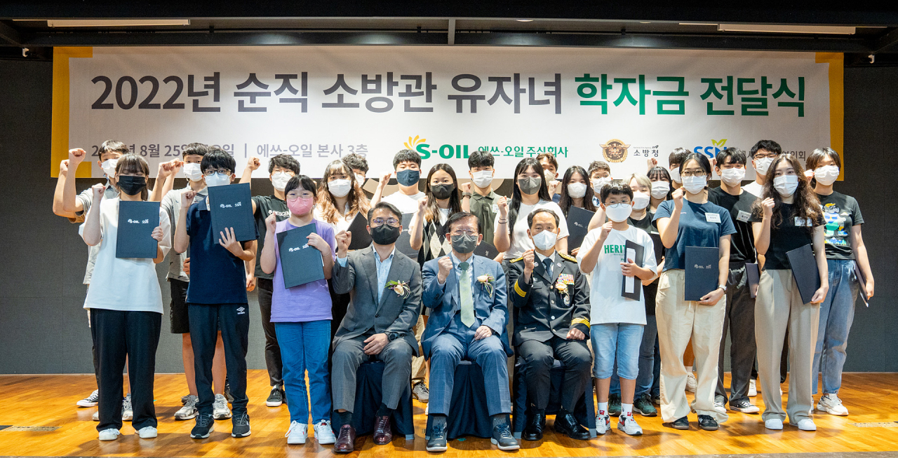 소방청과 S-오일은 홍영근 소방청 기획조정관(가운데에서 오른쪽)과 서상목 한국사회복지협의회 회장(가운데), 정상훈 에쓰오일 전무(가운데에서 왼쪽)가 자리한 가운데, 순직소방관 자녀들에게 장학금을 전달했다. [소방청 제공]