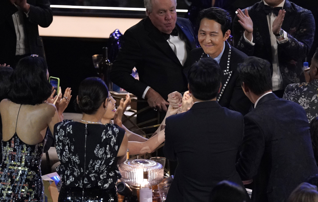 배우 이정재의 에미상 남우주연상 수상을 축하하는 '오징어 게임' 제작·출연진. [AP]