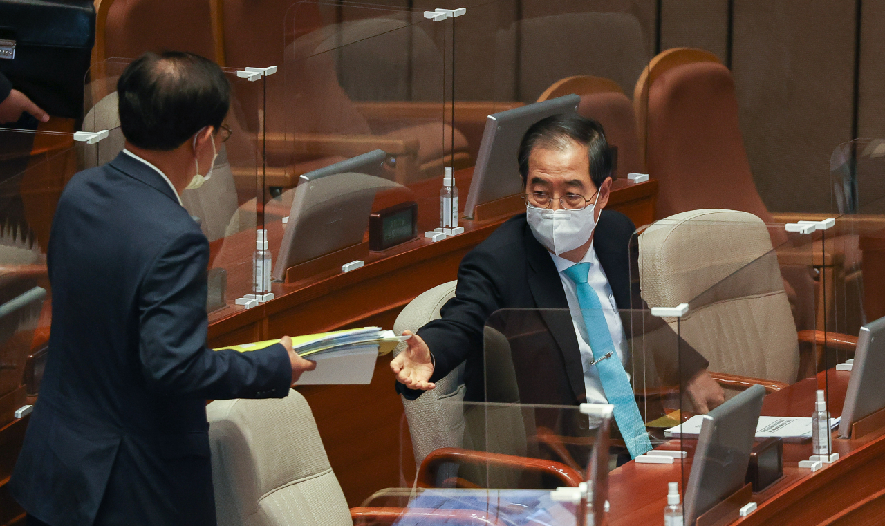 한덕수 국무총리가 20일 오후 국회에서 열린 본회의에서 자료를 건네받는 모습. 연합뉴스