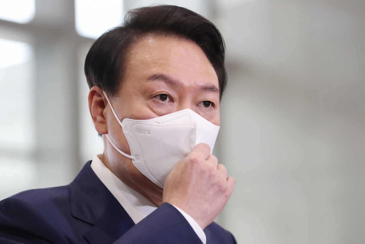 President Yoon Suk-yeol answers reporters' questions as he arrives for work at the presidential office in central Seoul on Monday. (Yonhap)