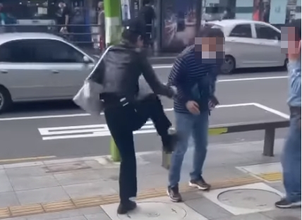지난 26일 서울 강북구 수유역 인근 한 거리에서 20대 여성이 흡연을 제지하던 공무원을 폭행하고 있다. [온라인 커뮤니티 캡처]