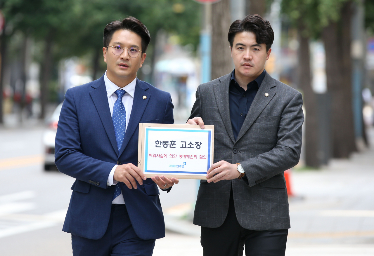 오영환 더불어민주당 원내대변인(오른쪽)과 전용기 비서실장이 28일 오후 서울 종로구 서울경찰청에서 한동훈 법무부 장관의 '허위사실에 의한 명예훼손죄 혐의'와 관련해 고소장을 접수하기 위해 이동하고 있다. [연합]