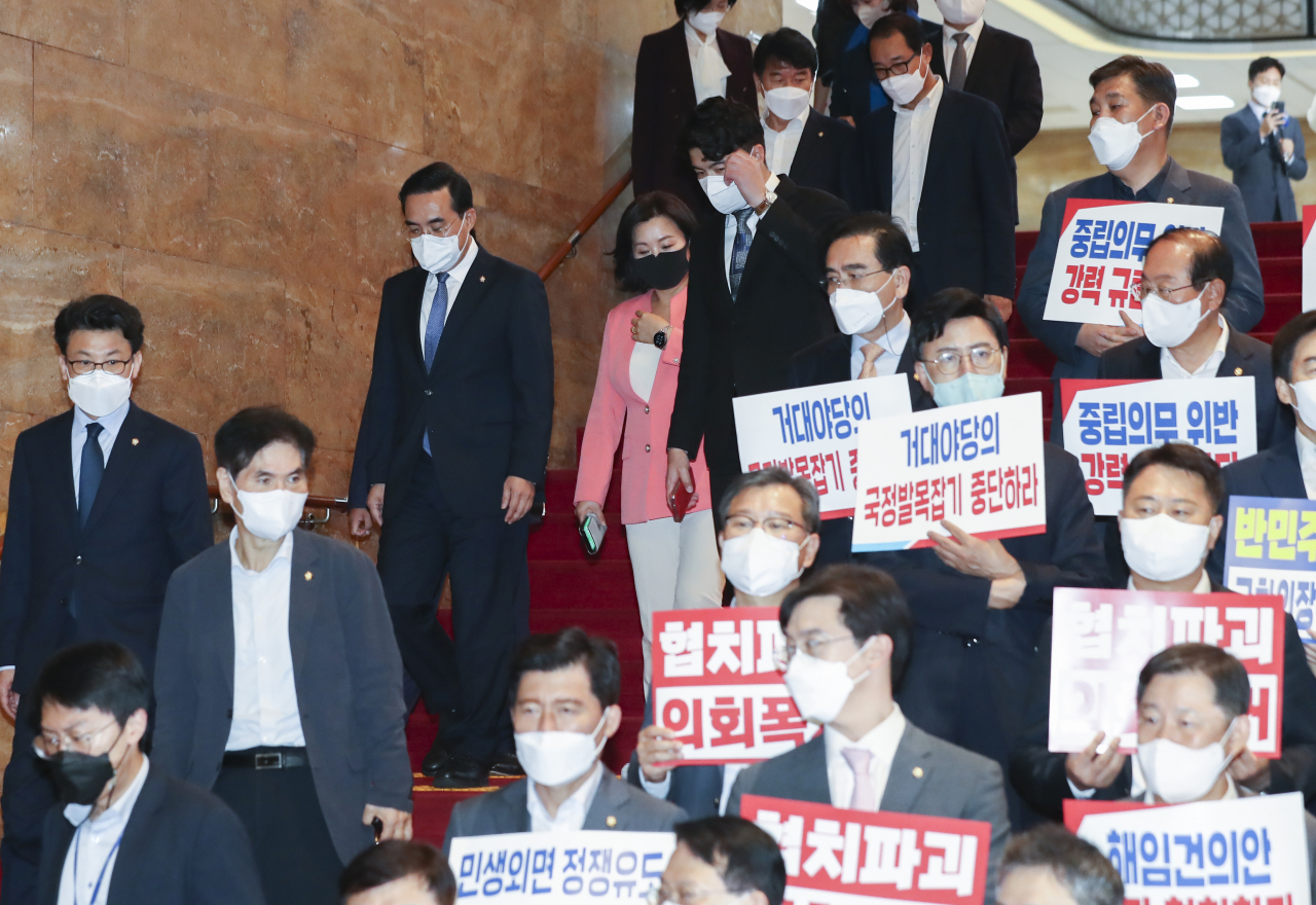 국민의힘 의원들이 29일 오후 국회 본관 계단에서 박진 외교부 장관 해임안에 항의하는 피켓 시위를 벌일 때 더불어민주당 의원들이 해임안 처리를 마친 뒤 본회의장에서 내려오고 있다. [연합]