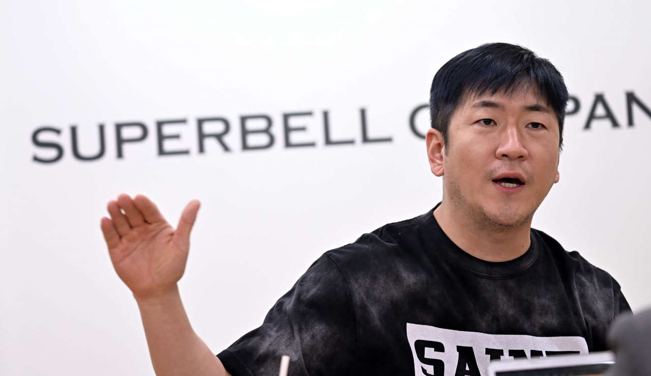 Veteran K-pop producer Ryan Jhun speaks in an interview with The Korea Herald at Superbell Company‘s headquarters in Mapo-gu, western Seoul. (Lee Sang-sub/The Korea Herald)