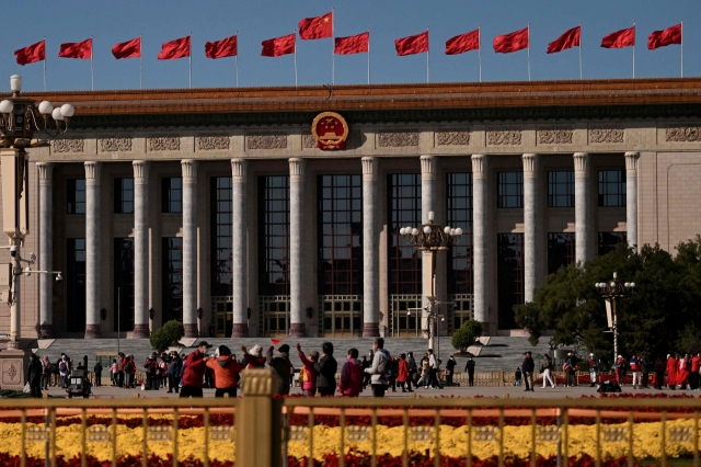 People walk on the street in front of the Great Hall of the People in Beijing, China on Monday. (Yonhap)