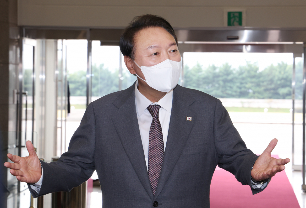 President Yoon Suk-yeol speaks to reporters as he arrives at the presidential office in Seoul on Friday. (Yonhap)
