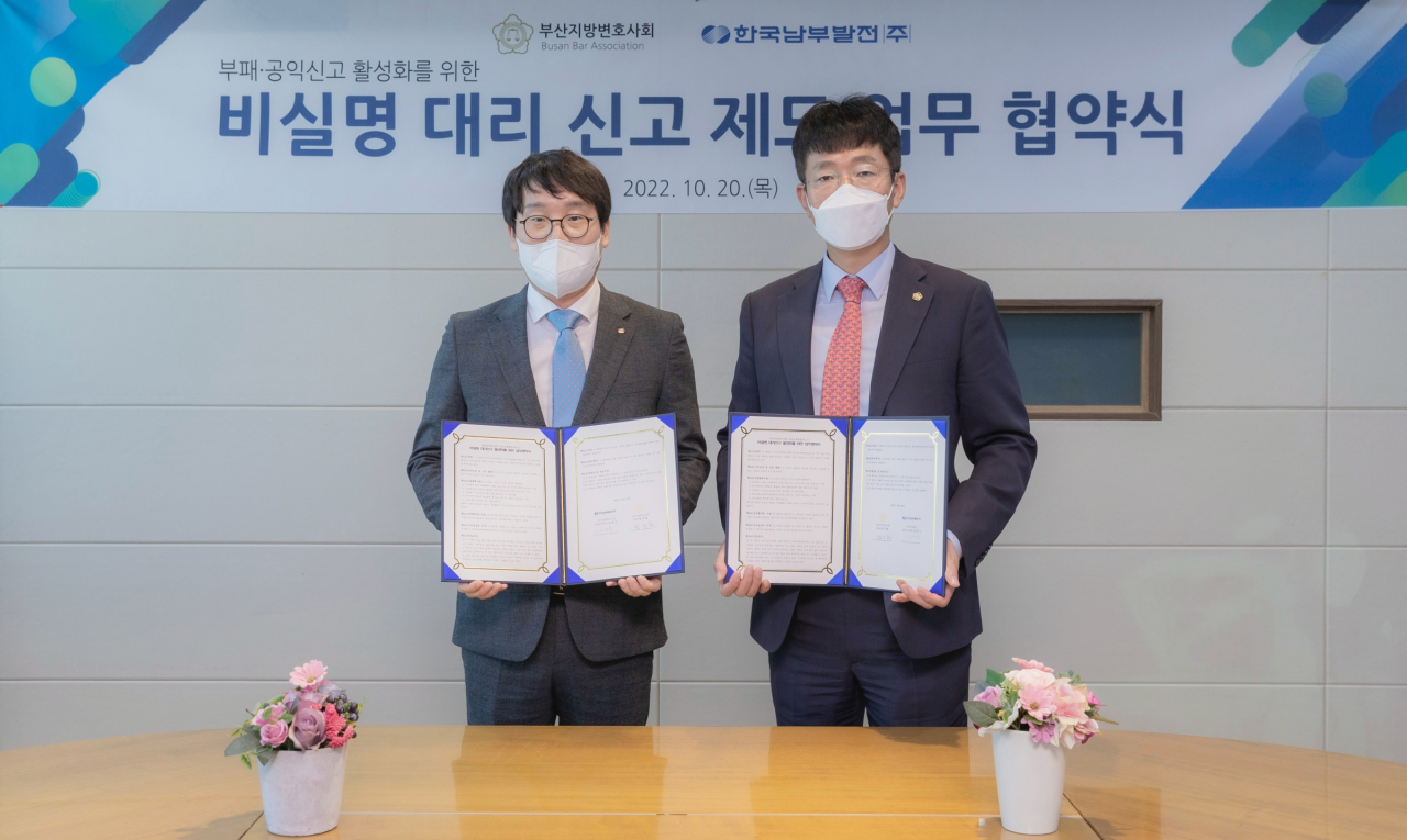 남부발전 김명수 상임감사위원(왼쪽)이 부산 본사 글로벌룸에서 부산지방변호사회 황주환 회장과 비실명 대리 신고 제도 업무협약을 맺고 기념촬영을 하고 있다. [남부발전 제공]
