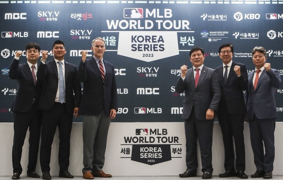 In this file photo from Sept. 19, 2022, Jim Small (3rd from L), Major League Baseball's senior vice president for international operations, and Heo Koo-youn (3rd from R), commissioner of the Korea Baseball Organization, pose for photos with other participants of the press conference for MLB World Tour's Korea Series at Busan City Hall in Busan, 325 kilometers southeast of Seoul. (Yonhap)