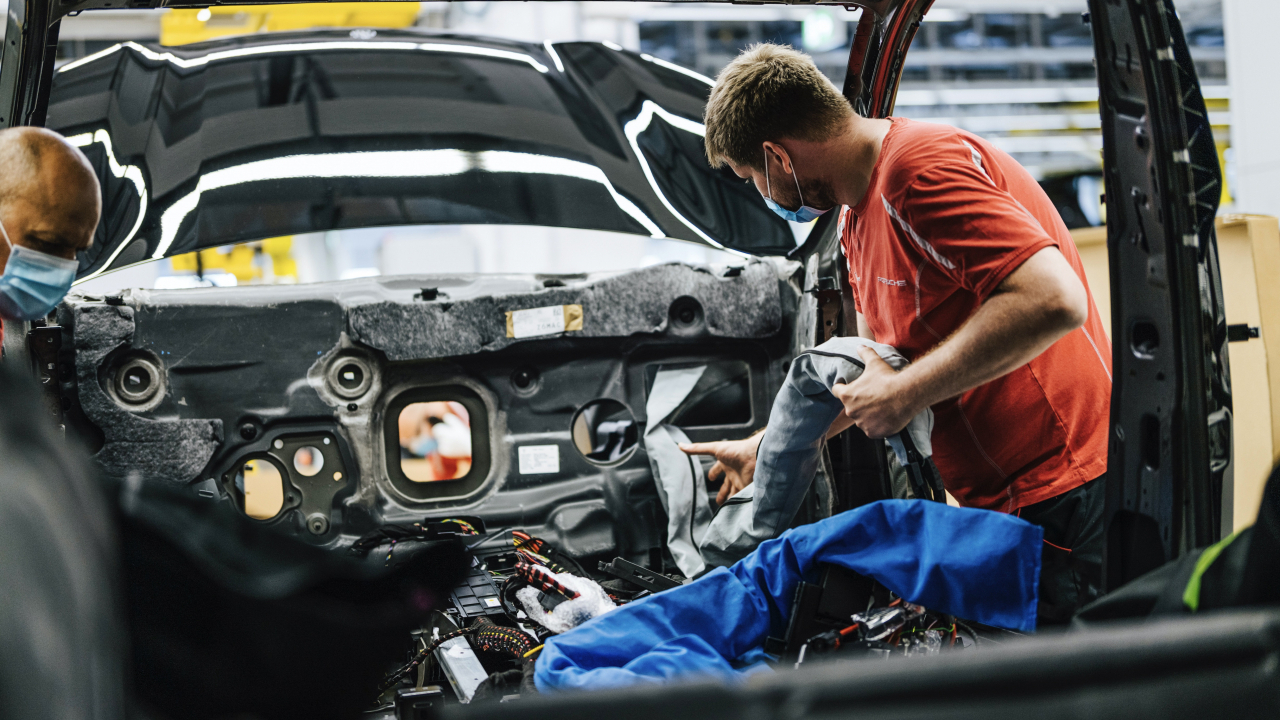 A Porsche employee works on a physical prototype of the all-electric Macan. (Porsche)