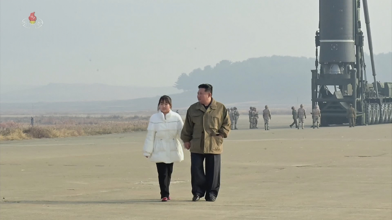 북한이 지난 18일 김정은 국무위원장의 지도 아래 신형의 대륙간탄도미사일 화성-17형을 시험 발사했다고 조선중앙TV가 20일 보도했다. 사진은 조선중앙TV가 이날 추가로 공개한 김정은 국무위원장이 딸과 손 잡고 나란히 걷는 모습. [조선중앙TV, 연합]
