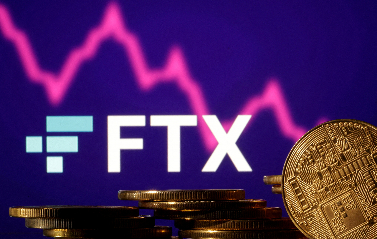 FILE PHOTO: FILE PHOTO: FILE PHOTO: Representations of cryptocurrencies are seen in front of displayed FTX logo and decreasing stock graph in this illustration taken November 10, 2022. REUTERS/Dado Ruvic/Illustration/File Photo/File Photo/File Photo