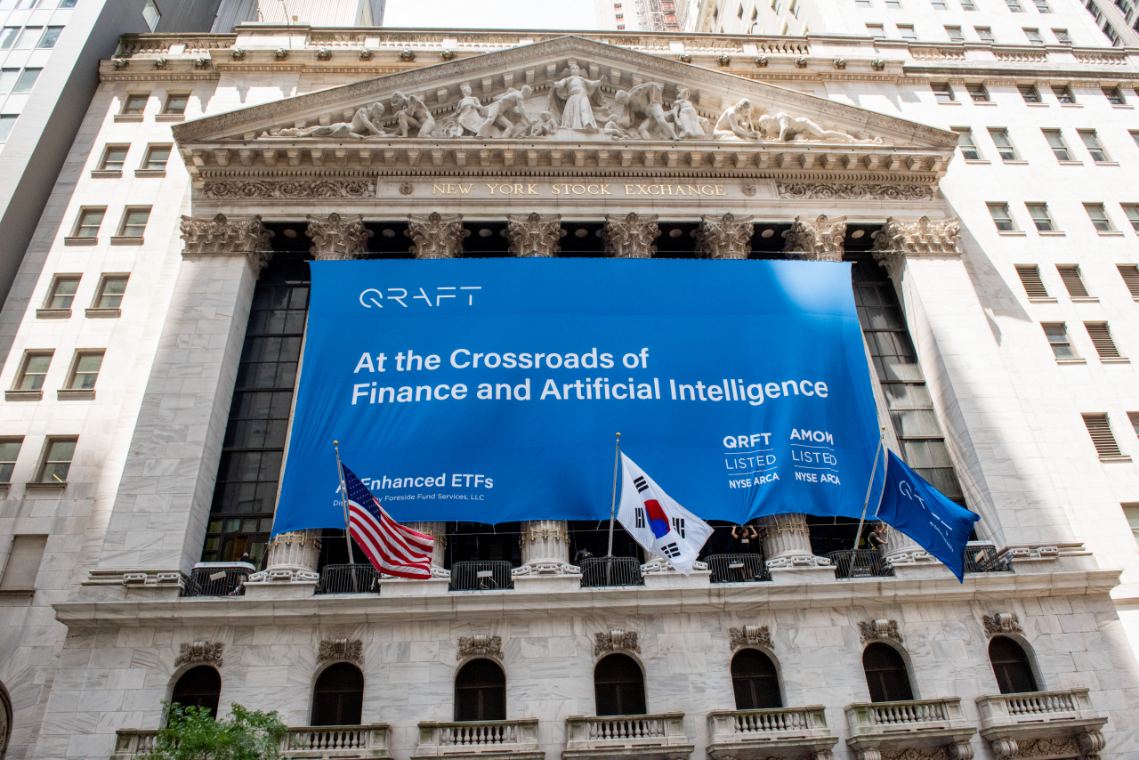 This photo shows a banner at the New York Stock Exchange celebrating the listing of Qraft Technologies' flagship ETF, AMOM, in May 2019. (Qraft Technologies)