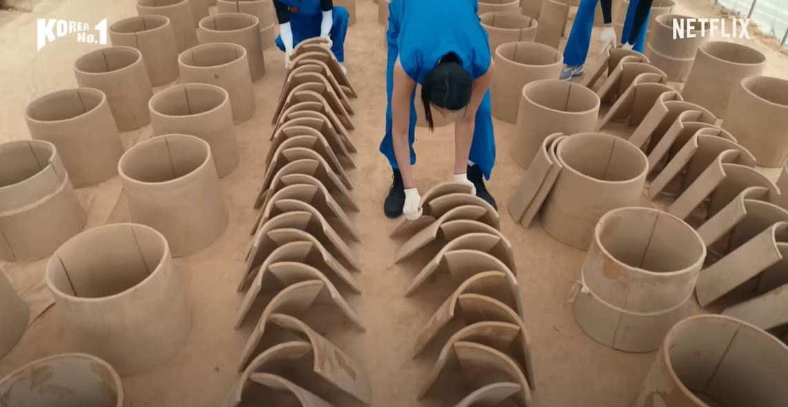Korean volleyball star Kim Yeon-koung making giwa, traditional Korean hanok roof tiles, on Netflix's"Korea No.1." (Netflix)