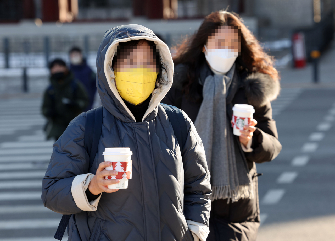 18일 오전 서울시청 앞에서 시민들이 발걸음을 옮기고 있다. [연합]
