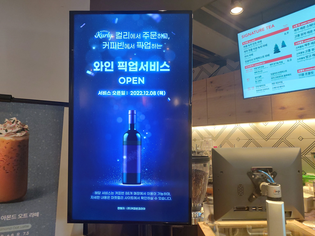 커피빈코리아는 마켓컬리와 협업해 8일부터 ‘와인 픽업 서비스’를 운영하고 있다. 마켓컬리를 통해 주문(스마트 오더)한 제품을 지정한 커피전문점의 매장에 들러 가져갈 수 있는 서비스다. 서울 종로구에 위치한 커피빈 종로구청앞점에서 와인 픽업서비스를 안내하는 화면이 나오고 있다. 김희량 기자