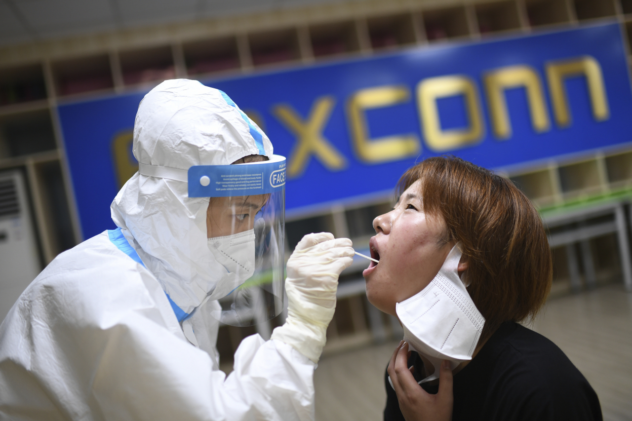 애플 아이폰 공급업체 폭스콘 직원이 코로나19 검사를 받고 있다. [AP]