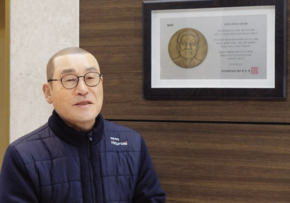 귀뚜라미그룹 최진민 회장이 서울 강서 마곡에 있는 본사에서 장학사업과 사회사업 배경과 계획을 밝히고 있다. 벽엔 한국공학한림원이 지난해 3월 최 회장에게 준 감사패가 걸려 있다. 그는 1997년부터 ‘한국공학한림원 대상과 청넌공학인상’을 제정, 26년간 매년 상금 2억5000만원을 후원해 왔다. 총 70억원 꼴이다. [귀뚜라미 제공]