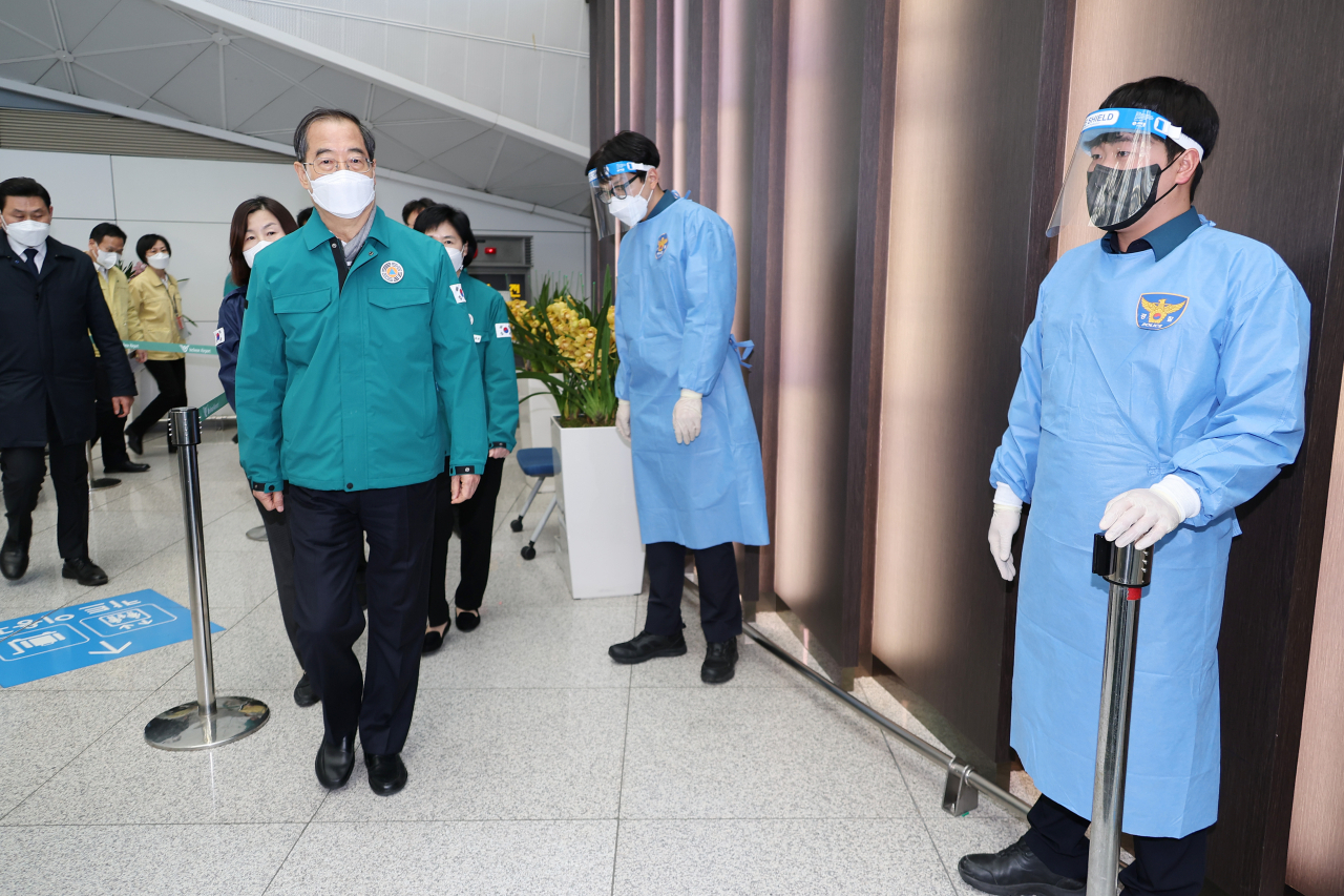 한덕수 국무총리가 2일 인천국제공항의 중국발 입국자 유전자증폭(PCR) 검사 현장과 대기 장소를 방문해 현황을 보고 받고 현장을 점검하고 있다. [연합]