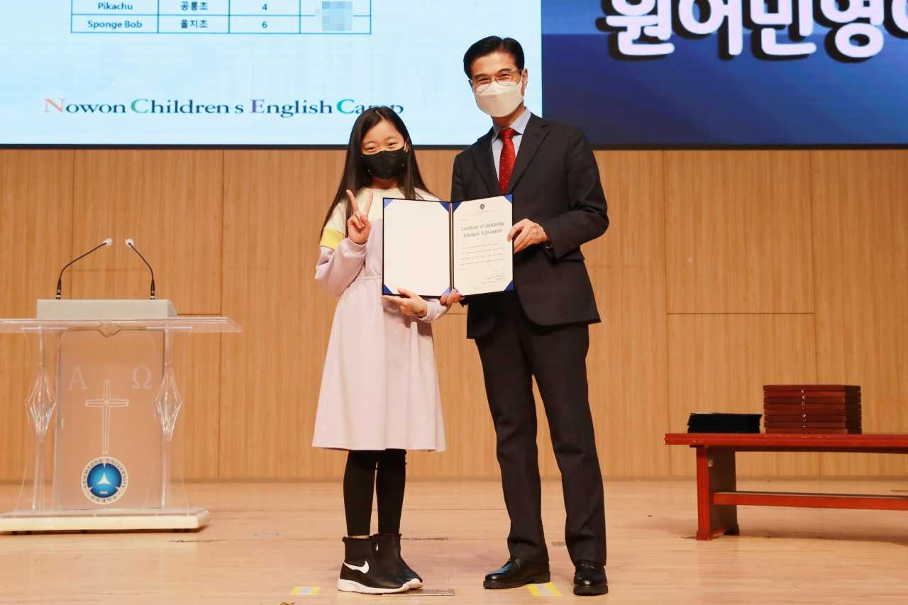 김일목 삼육대학교 총장이 영어캠프 수료식에서 우수 학생에게 총장상을 수여하며 기념사진을 촬영하고 있다.[삼육대학교 제공]