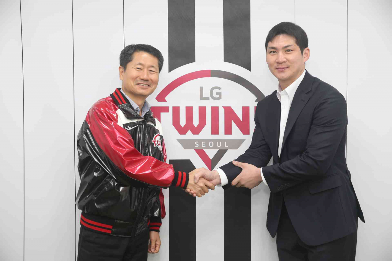 오지환(오른쪽)과 김인석 LG 대표이사가 19일 6년 124억 계약에 합의하고 악수를 나누고 있다./LG 제공