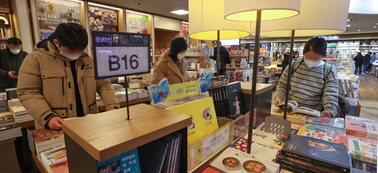 지난 16일 시민들이 서울 시내 한 대형서점에서 마스크를 착용하고 책을 읽고 있다. [연합]
