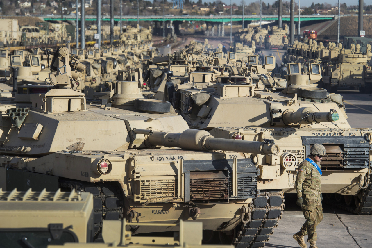 A soldier walks past a line of M1 Abrams tanks, Nov. 29, 2016, at Fort Carson in Colorado Springs, Colo. In what would be a reversal, the Biden administration is poised to approve sending M1 Abrams tanks to Ukraine, U.S. officials said Tuesday, as international reluctance toward sending tanks to the battlefront against the Russians begins to erode. The decision could be announced as soon as Wednesday though it could take months or years for the tanks to be delivered. (File Photo - The Gazette via AP)