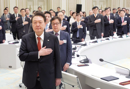 윤석열 대통령이 지난 30일 오후 청와대 영빈관에서 열린 금융위원회 업무보고에서 국기에 경례하고 있다. [연합]