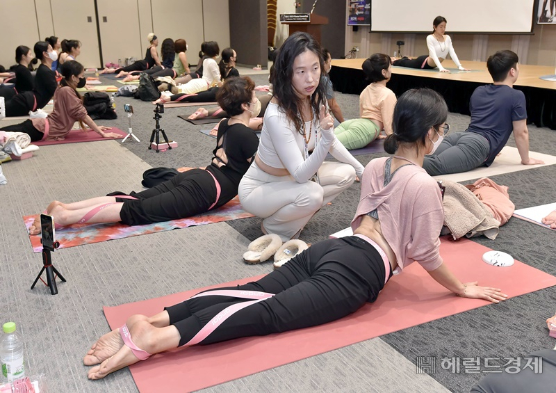 애슬레저 리딩 브랜드 안다르가 지난 18일 서울 삼성동 코엑스에서 피트니스 산업 컨퍼런스 '서클즈 2023 컨퍼런스'에 참가해 대규모 요가 클래스를 진행한 가운데 참가자들이 요가 동작을 배우고 있다. 사진=안다르 제공