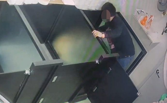An image from a CCTV video shows a man beating a dog in a cage at a pet boarding center in Cheongju, North Chungcheong Province, on Jan. 31. (KAWA)